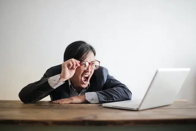 Man screaming at laptop